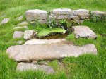 Stone No 4 lies in front of the well near Stones Lane.